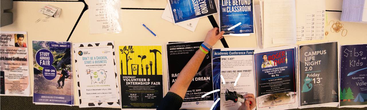 Student stamping posters to be posted on campus